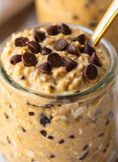 Bowl of cookie dough overnight oats topped with chocolate chips and nuts