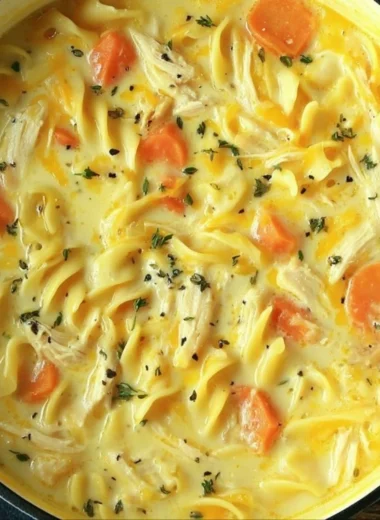 Delicious bowl of Crack Chicken Noodle Soup with chicken, noodles, and herbs