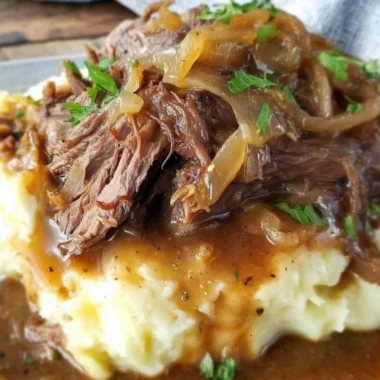 Delicious French Onion Pot Roast served with melted cheese and caramelized onions