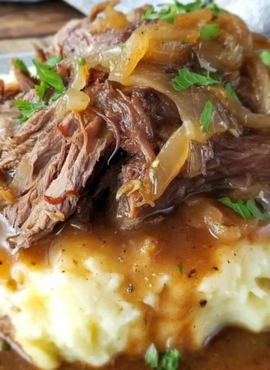 Delicious French Onion Pot Roast served with melted cheese and caramelized onions