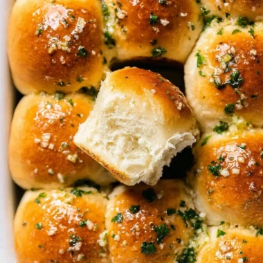 Homemade garlic bread rolls, golden brown and garnished with parsley