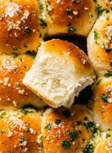 Homemade garlic bread rolls, golden brown and garnished with parsley