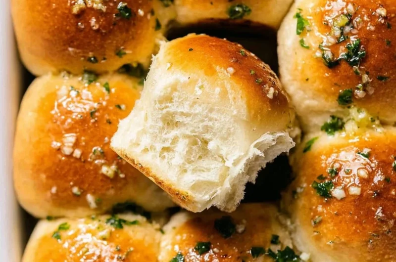 Homemade garlic bread rolls, golden brown and garnished with parsley