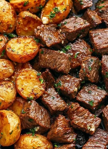 Delicious garlic butter steak bites served with crispy potatoes on a plate
