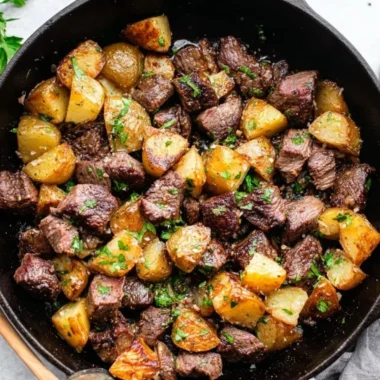 Garlic butter steak bites with tender potatoes on a plate