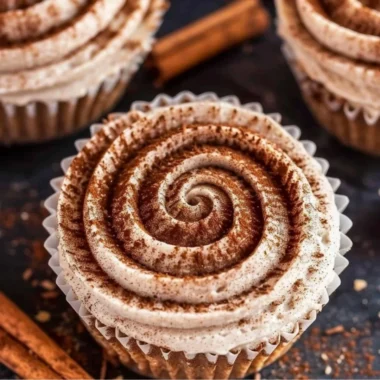 Mini No Bake Cinnamon Roll Cheesecakes topped with cinnamon and whipped cream