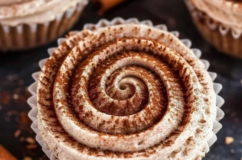 Mini No Bake Cinnamon Roll Cheesecakes topped with cinnamon and whipped cream