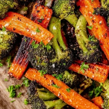 Delicious roasted broccoli and carrots served on a plate.
