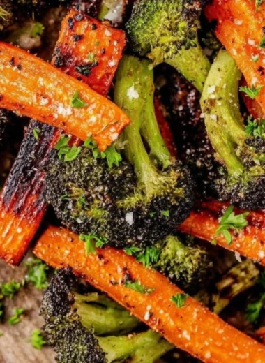 Delicious roasted broccoli and carrots served on a plate.