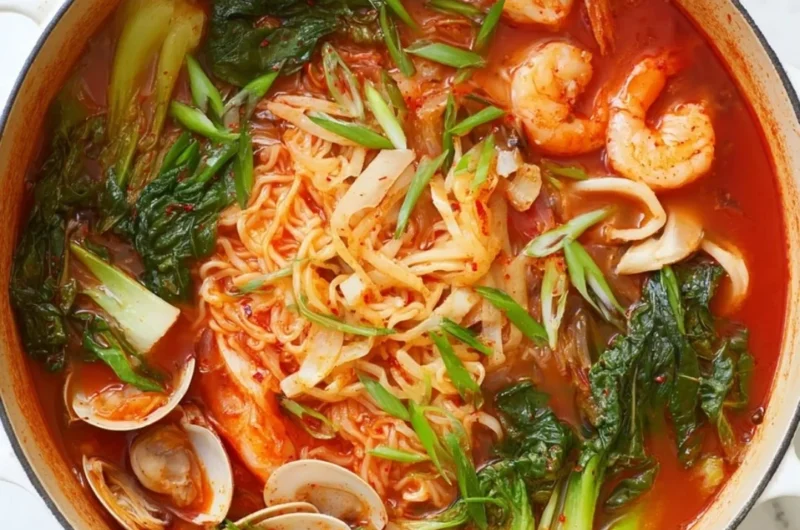 Bowl of spicy seafood noodle soup with fresh seafood and colorful vegetables