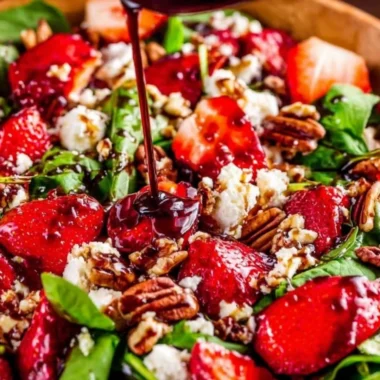 Spinach strawberry salad topped with pecans for a healthy and fresh meal