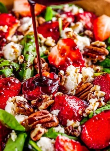 Spinach strawberry salad topped with pecans for a healthy and fresh meal