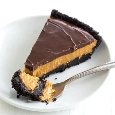 No bake chocolate peanut butter pie sliced and served on a plate