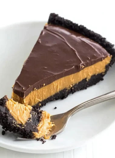 No bake chocolate peanut butter pie sliced and served on a plate