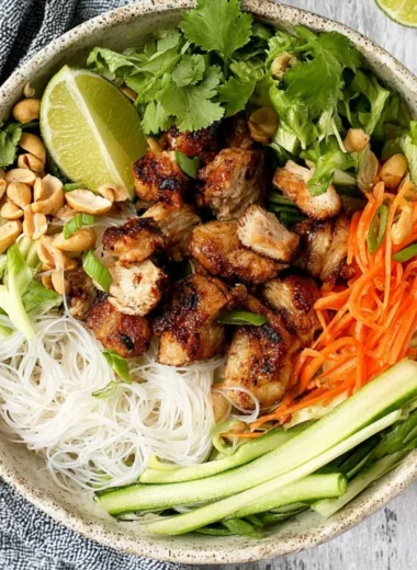Vietnamese noodle bowl topped with lemongrass chicken and fresh herbs